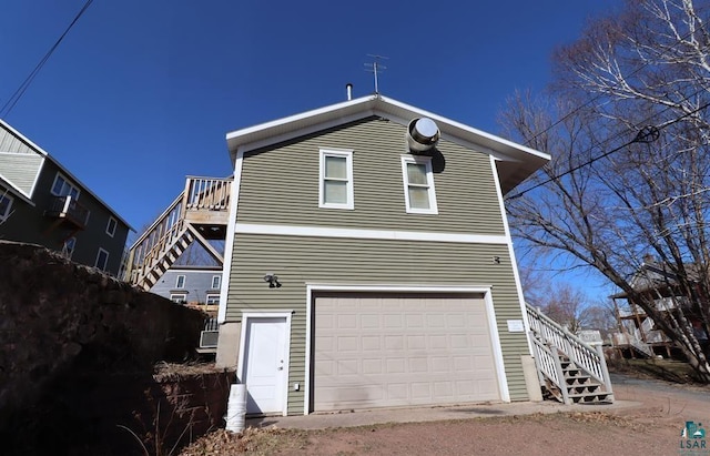 exterior space featuring stairway and an attached garage