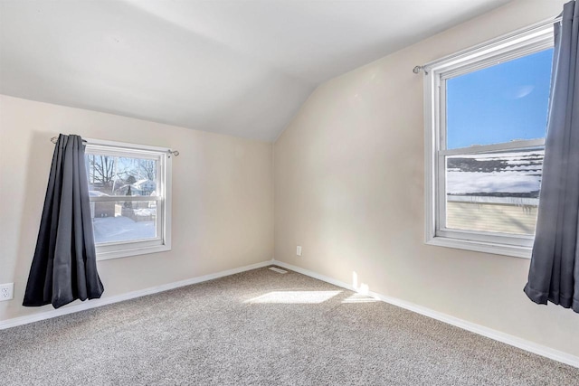 bonus room with lofted ceiling, carpet flooring, and baseboards