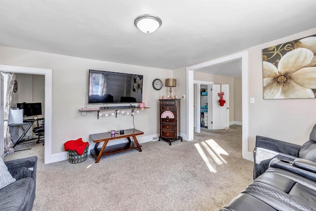 living room featuring light carpet and baseboards