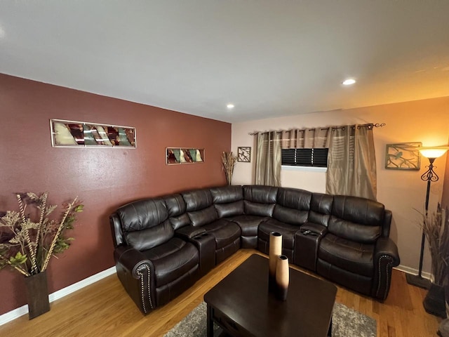 living room featuring recessed lighting, baseboards, and wood finished floors