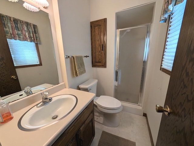 full bathroom featuring a stall shower, vanity, and toilet