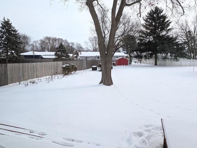 yard covered in snow featuring fence