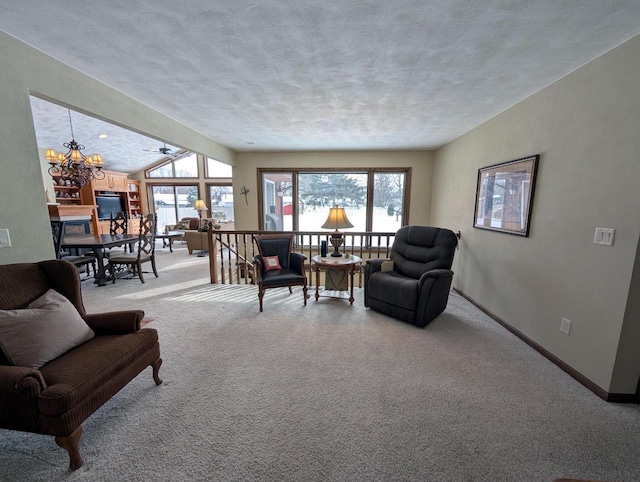 living area featuring light carpet, a healthy amount of sunlight, baseboards, and a chandelier