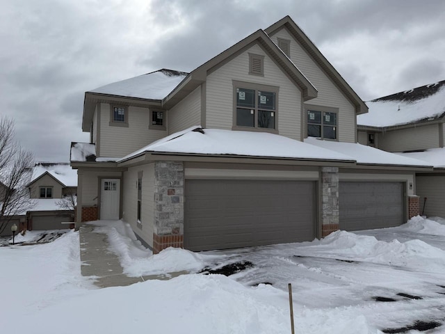 view of front facade featuring an attached garage and stone siding