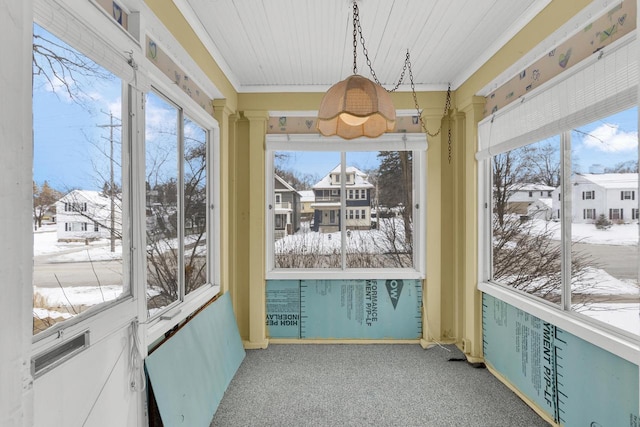 sunroom with a residential view and a wealth of natural light