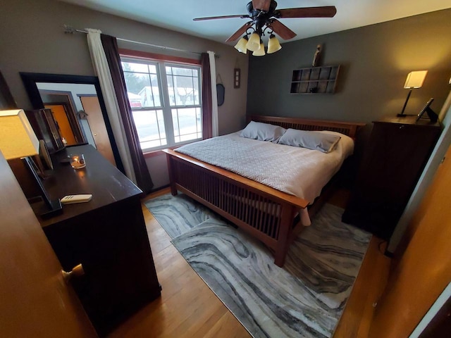 bedroom with a ceiling fan and wood finished floors