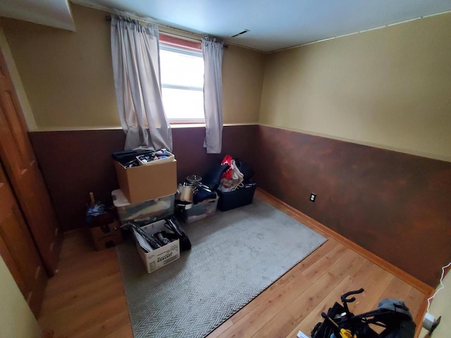 bedroom featuring visible vents and wood finished floors