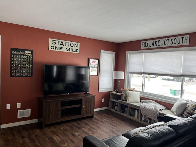 living area featuring dark wood-style floors, visible vents, and baseboards