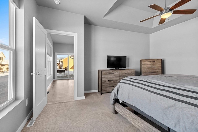 bedroom with baseboards, ceiling fan, and light colored carpet