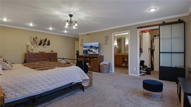 bedroom with carpet, a walk in closet, visible vents, ornamental molding, and connected bathroom