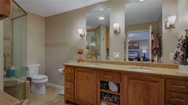 ensuite bathroom featuring toilet, a sink, ensuite bath, and double vanity