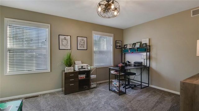 carpeted office with an inviting chandelier, visible vents, and baseboards