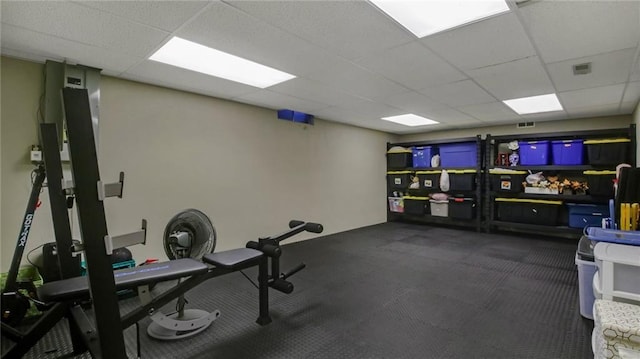 workout room featuring a paneled ceiling and visible vents