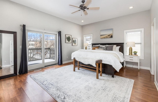 bedroom featuring access to outside, dark wood-type flooring, multiple windows, and baseboards