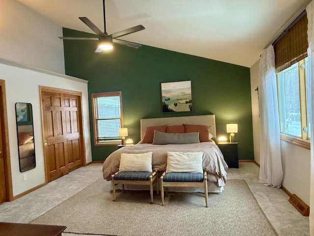 bedroom featuring a ceiling fan, light colored carpet, and baseboards