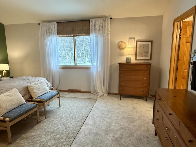 sitting room with visible vents, baseboards, and light colored carpet