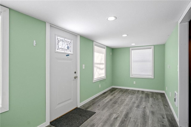 foyer entrance featuring light wood finished floors, recessed lighting, and baseboards