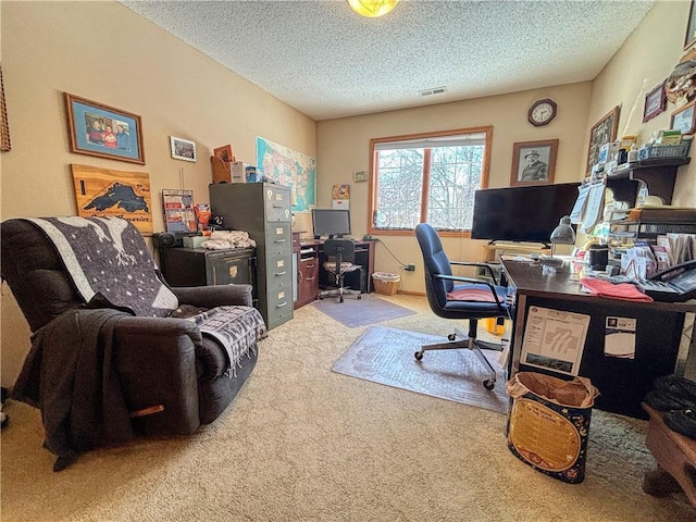 carpeted home office with visible vents and a textured ceiling