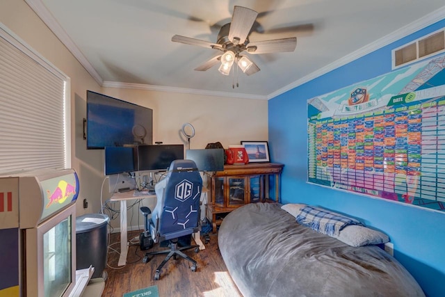 office area featuring ceiling fan, wood finished floors, visible vents, and crown molding