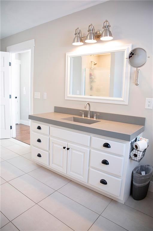 bathroom with tile patterned floors and vanity