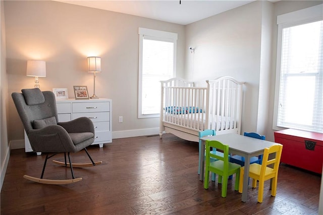 bedroom featuring dark wood-style floors and baseboards