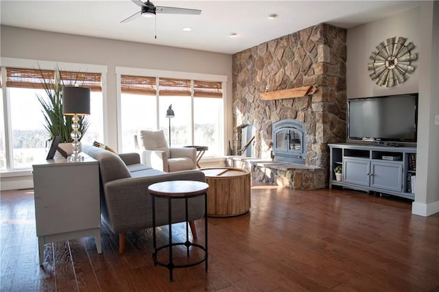 living room with dark wood-style floors, plenty of natural light, and a fireplace