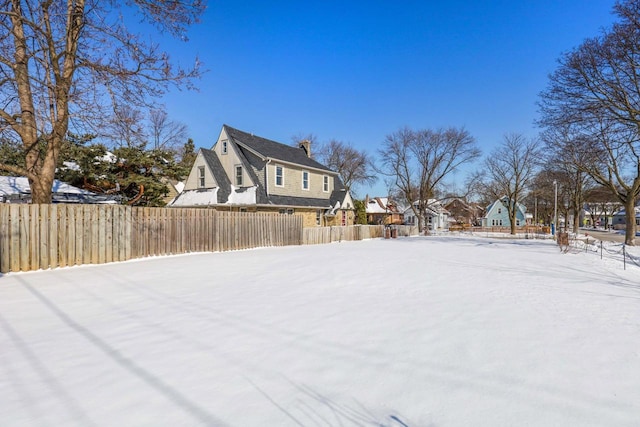 exterior space featuring a residential view and fence