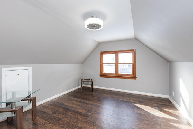 bonus room featuring dark wood-style floors, lofted ceiling, and baseboards