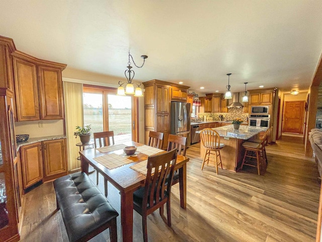 dining space featuring light wood-type flooring and recessed lighting