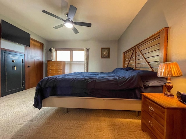 bedroom with light carpet and a ceiling fan