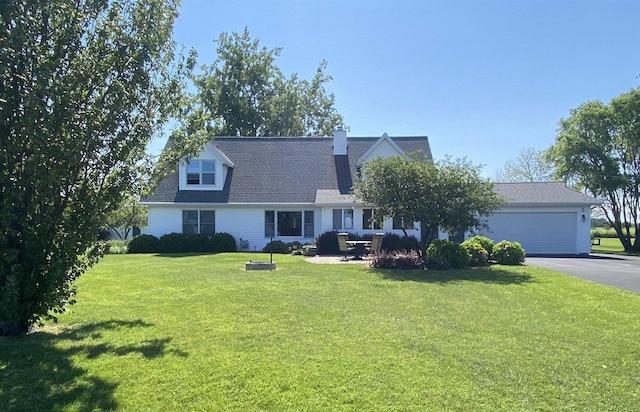 cape cod house with driveway, a front lawn, a chimney, and an attached garage