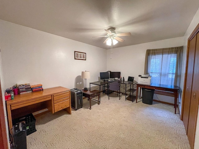 office area featuring light colored carpet and ceiling fan