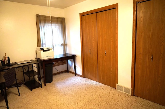 home office with light carpet, baseboards, and visible vents