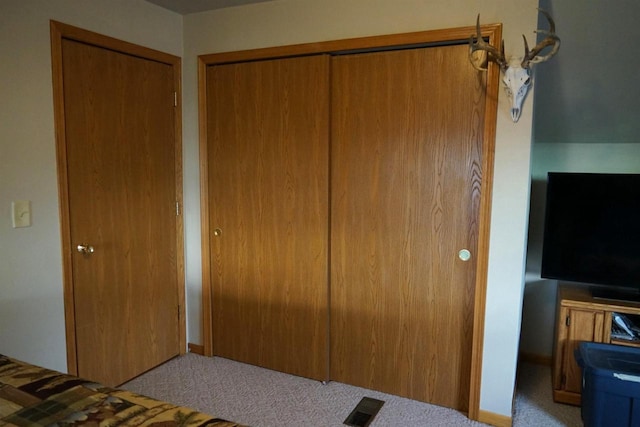 unfurnished bedroom featuring a closet, visible vents, and light colored carpet