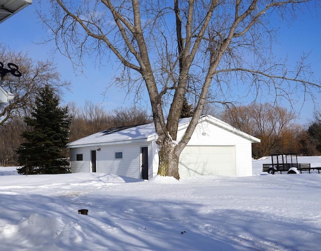 view of front facade with a garage and an outbuilding