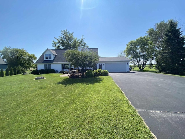 view of front of home with driveway, an attached garage, and a front lawn