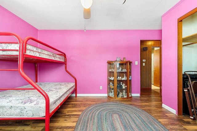 bedroom featuring dark wood finished floors and baseboards