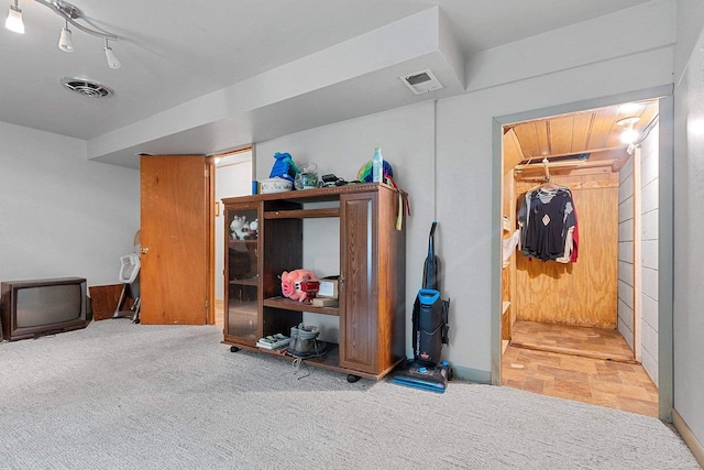 interior space with carpet floors and visible vents