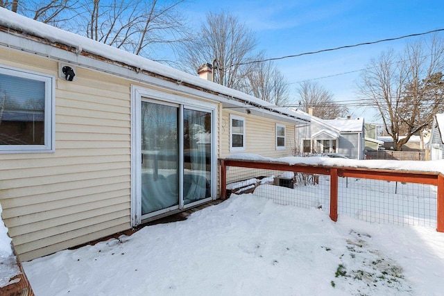 snow covered deck with fence