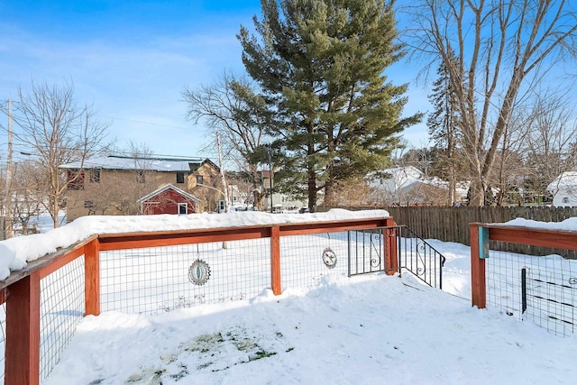 yard layered in snow with fence