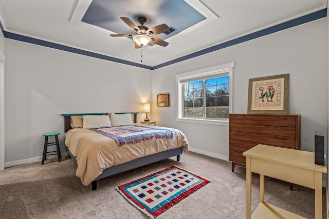 bedroom with carpet floors, ceiling fan, baseboards, and a raised ceiling