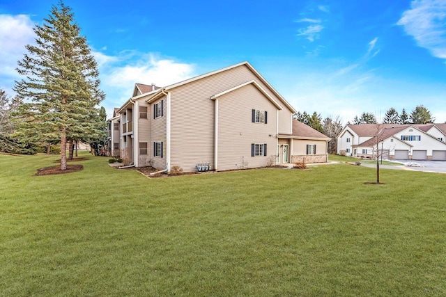 view of side of property with a residential view and a yard