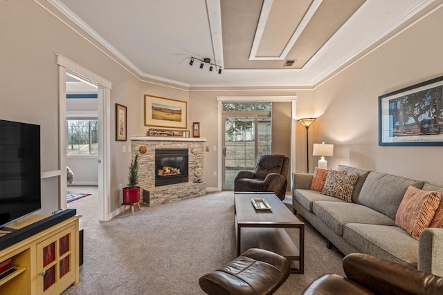 living area with carpet, ornamental molding, a fireplace, and baseboards