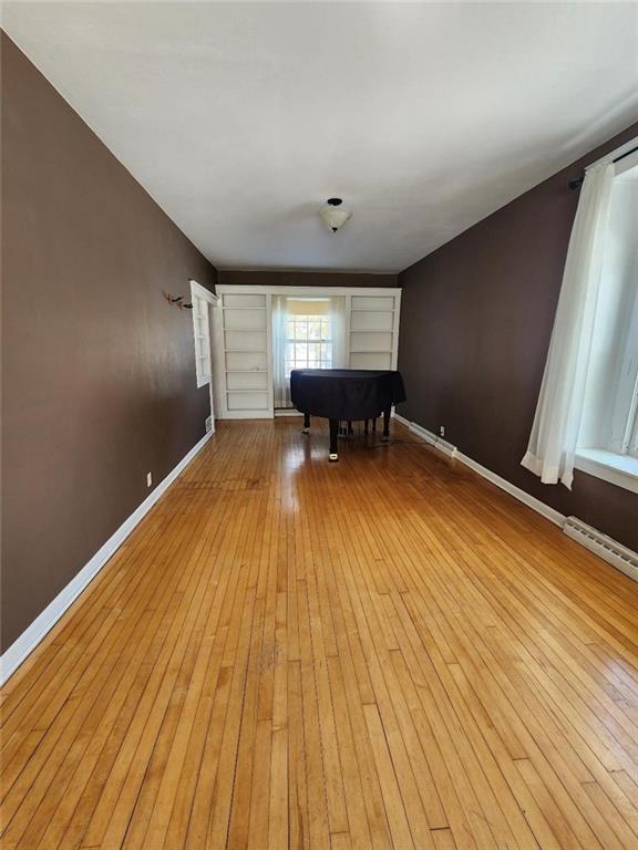 interior space with billiards, light wood-style flooring, and baseboards