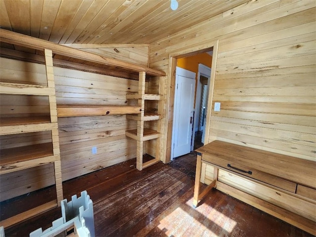 unfurnished bedroom featuring wooden ceiling, wooden walls, and dark wood-style flooring