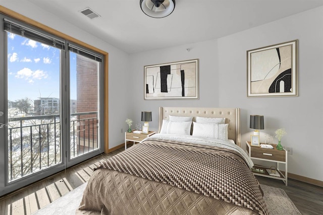 bedroom featuring baseboards, dark wood finished floors, visible vents, and access to exterior