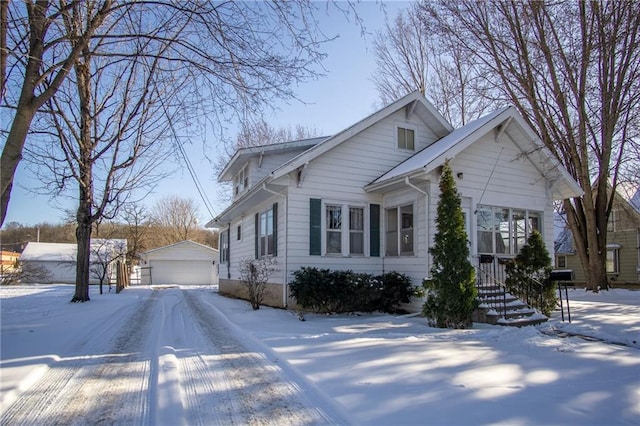 view of front of house featuring an outdoor structure and a detached garage