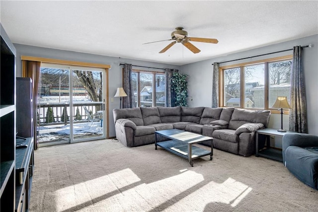 living room featuring a ceiling fan and light colored carpet