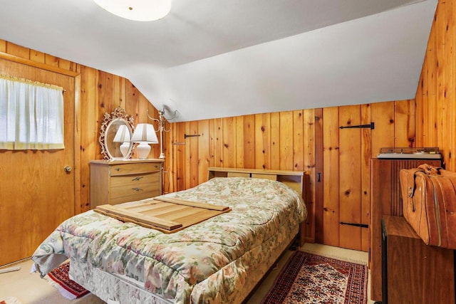 bedroom with lofted ceiling and wood walls