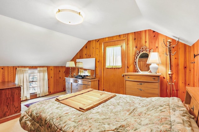 bedroom with vaulted ceiling, wood walls, and light carpet